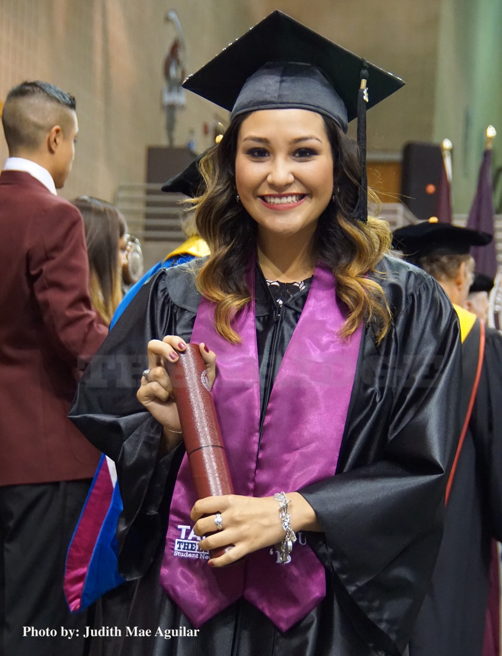 Khloe Torres proudly displays her diploma after receiving it from TAMIU administration.