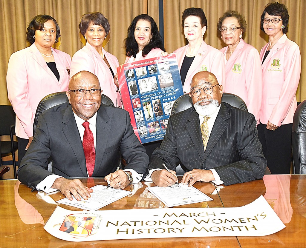GLENN LEWIS/The Yearbook Grambling State University President Willie D. Larkin (seated right) and City of Grambling Major Ed Jones sign proclamations declaring March as Women’s History Month at the university, in the city and in the community. Looking on are members of the Epsilon Psi Omega Chapter of Alpha Kappa Alpha Sorority, Inc., which is sponsoring the national observance here. Members include (L-R) Debra Minnifield, treasurer of the chapter; Annie H. Hamlin, membership chairman; Loretta Gallot-Lee, chairman of the National Women’s History Committee; Dr. Mildred Gallot, co-chairman of the committee; Gloria Garner committee member; and Sylvia Crawley, committee member. Theme for the national observance is “Honoring Women in Public Service and Government.”
