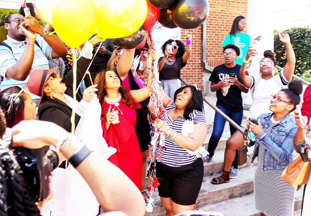 Miss GSU 2016-2017 Astra Watts (center) releases balloons after hearing her name announced as the winner.