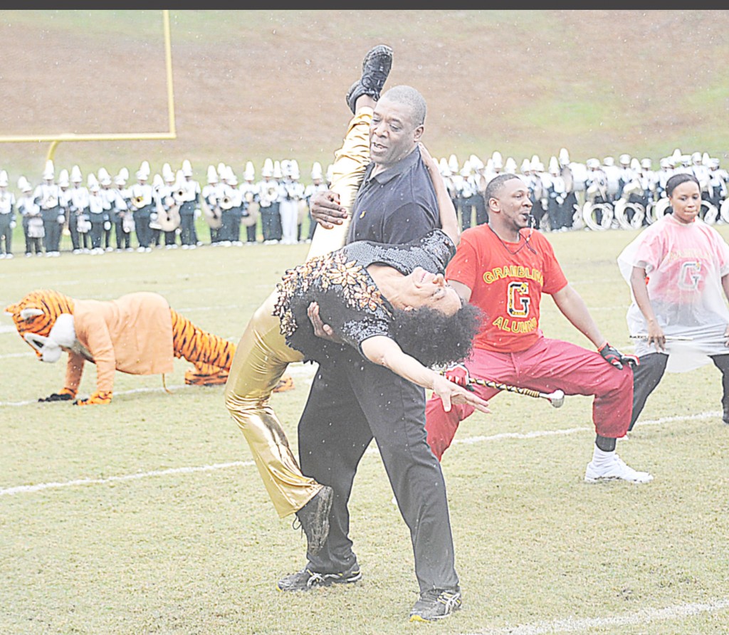 JORDAN CAMERON/The Yearbook Terry Lilly, director of the GSU cheerleading squad, and Virgie Broussard Pradia, former Orchesis director, put on a show as the alumni band takes the field during the Homecoming halftime show.
